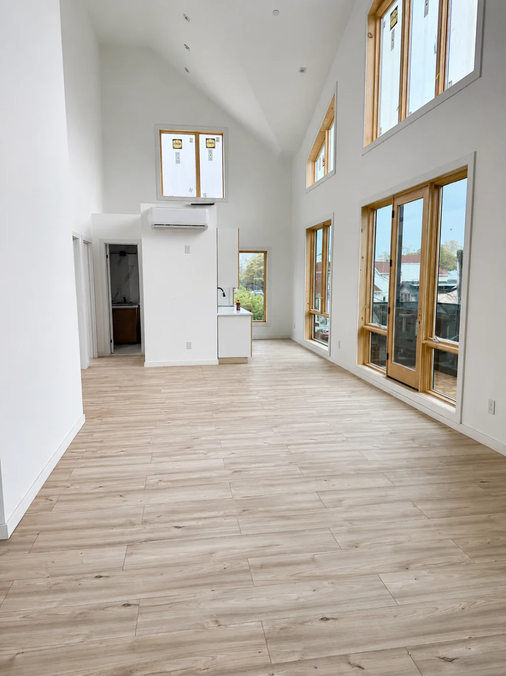 Mini-split indoor unit on a high-ceiling living room wall